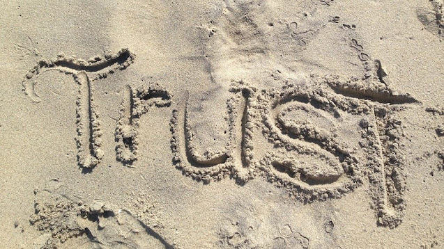 Trust écrit sur le sable.