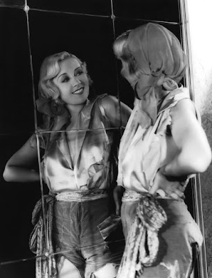 Joan Blondell looking in the mirror