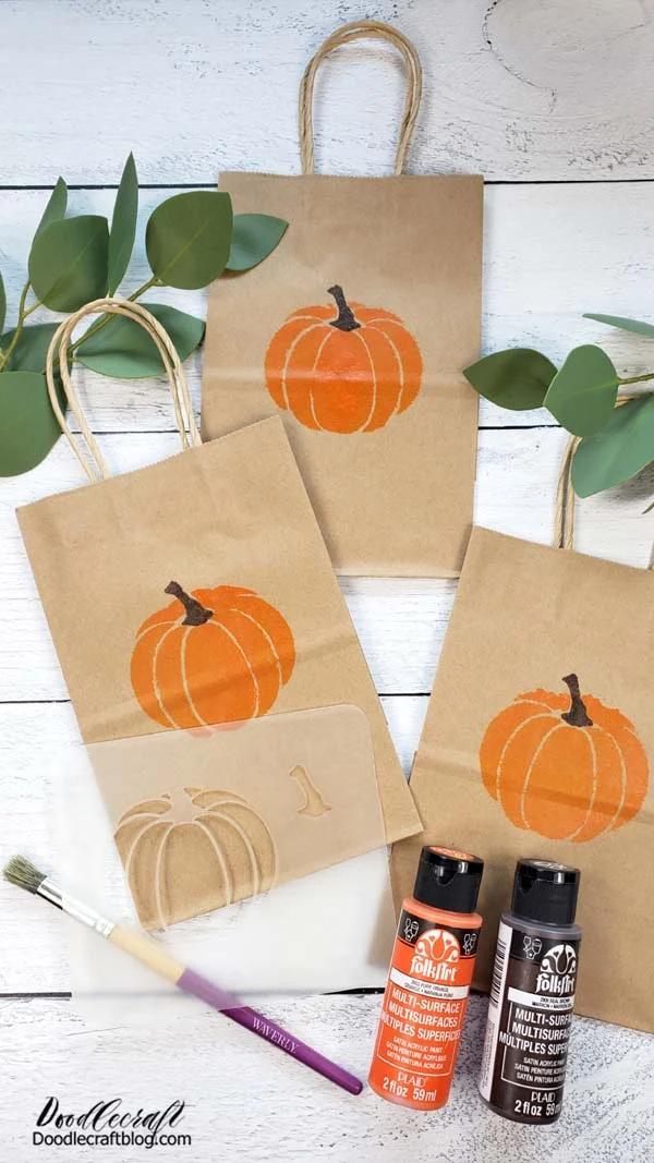 How to Stencil Pumpkin Treat Bags!  Make the perfect Halloween or Autumn Goodie bags using a custom reusable stencil and Plaid Folk Art paint.   These cute kraft bags are perfect for filling with treats for the perfect holiday handouts.   This two part stencil is a great way to mass produce something that is adorable, inexpensive and makes everything a little more special!