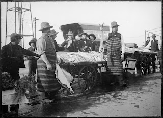 men in striped aprons at fish market in Coburg