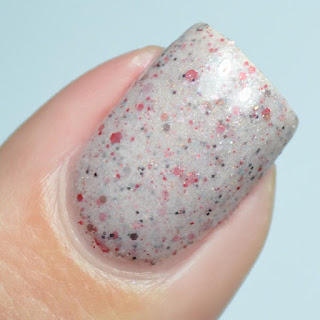 beige nail polish with red glitter