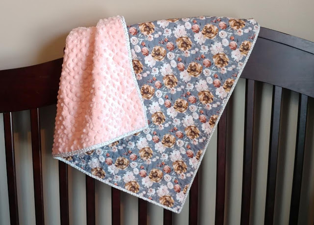 This trendy floral whole cloth quilt with soft minky back is the perfect baby quilt for a girl!