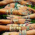 Fully decorated boho's hands with jewelries 