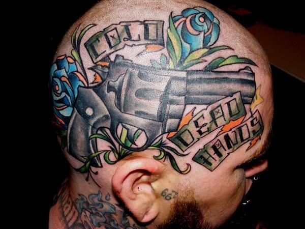 Head tattoo with gun and