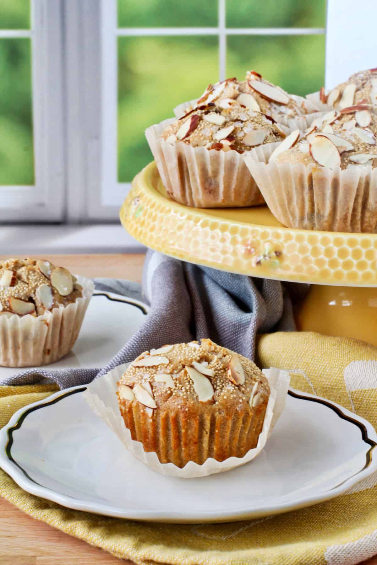 Sourdough Multi-grain Grape Muffins on a yellow cake stand.