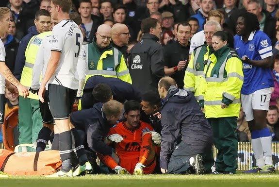 Tottenham goalkeeper Hugo Lloris is attended to by medical staff after being involved in a collision