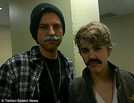 Matching look: Bieber's friend also tried on a fake moustache