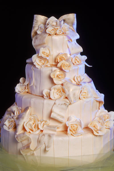 Extremely pale pink four tier round wedding cake with many gorgeous sugar