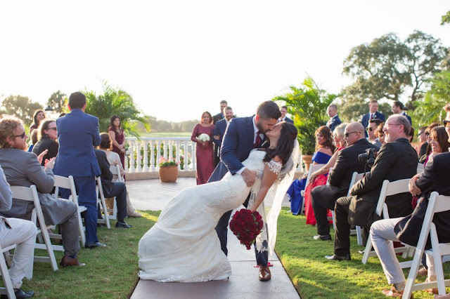 groom kisses bride after ceremony