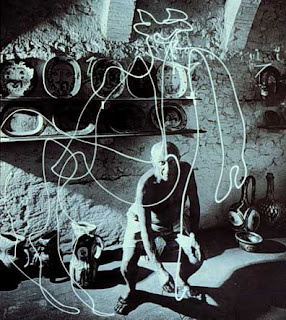 Photograph of Picasso drawing a bull in light