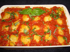 STUFFED SHELLS WITH HAM AND CHEESE, MARINARA SAUCE YIELDS: 22 STUFFED SHELLS INGREDIENTS FOR STUFFING 22 jumbo shells 1 tbsp. olive oil 1 cup diced yellow onions 2 minced garlic cloves 1¼ cup ricotta cheese 1¼ cup mozzarella cheese 1 cup grated Swiss cheese 1 tbsp. pesto or fresh basil leaves. (I always keep it in the freezer) ½ tsp. salt 1 tbsp. melted butter to coat the bottom of a baking tray MARINARA TOMATO SAUCE 2 tbsp. olive oil ¾ cup diced yellow onions 28 oz. can diced tomatoes 28 oz. can crushed tomatoes 1 tsp. oregano leaves 2 tbsp. sliced fresh basil leaves ¼ tsp. red pepper flakes 1 bay leave 3 tsp. salt ½ tsp. sugar METHOD FOR MARINARA SAUCE Put the oil in a pot and at moderate heat cook onions and garlic until begins to get lightly brown. Add diced tomatoes, crushed tomatoes, oregano, red pepper flakes, bay leave, salt and sugar. Slowly bring the liquid to a boil. Simmer for about 20 minutes. At the last minute add basil leaves and turn off the heat. METHOD FOR MAKING THE STUFFING Cook half way jumbo shells in salty boiling water and cool off with running cold water. Set aside. Heat a small frying pan with the oil and cook garlic and onions together, but do not brown it. Let it cool off. In a bowl mix ricotta cheese, mozzarella cheese, Swiss cheese, onions and garlic mix, pesto, salt and ham. Coat with melted butter the bottom of a baking tray. Stuff the shells with the ham cheese and place in the baking dish. Pour tomato sauce on top of the stuffed shells and bake at 350° F. for about 20 minutes, until the pasta shells are cooked.  Sprinkle some fresh basil leaves and parmesan or pecorino cheese if desired. INGREDIENTS FOR STUFFING 22 jumbo shells 1 tbsp. olive oil 1 cup diced yellow onions 2 minced garlic cloves 1¼ cup ricotta cheese 1¼ cup mozzarella cheese 1 cup grated Swiss cheese 1 tbsp. pesto or fresh basil leaves. (I always keep it in the freezer) ½ tsp. salt 1 tbsp. melted butter to coat the bottom of a baking tray METHOD FOR MAKING THE STUFFING Cook half way jumbo shells in salty boiling water and cool off with running cold water. Set aside. Heat a small frying pan with the oil and cook garlic and onions together, but do not brown it. Let it cool off. In a bowl mix ricotta cheese, mozzarella cheese, Swiss cheese, onions and garlic mix, pesto, salt and ham. Coat with melted butter the bottom of a baking tray. Stuff the shells with the ham cheese and place in the baking dish. Pour tomato sauce on top of the stuffed shells and bake at 350° F. for about 20 minutes, until the pasta shells are cooked.  Sprinkle some fresh basil leaves and parmesan or pecorino cheese if desired.