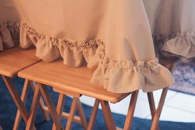 Pin the ruffle so it skims the floor; use a table or tray tables to bring it to eye level | Candy Hearts & Paper Flowers