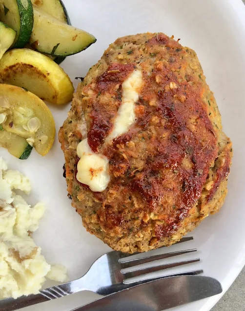 Mini vegetable and mozzarella turkey meatloaf on a serving plate with side dishes.