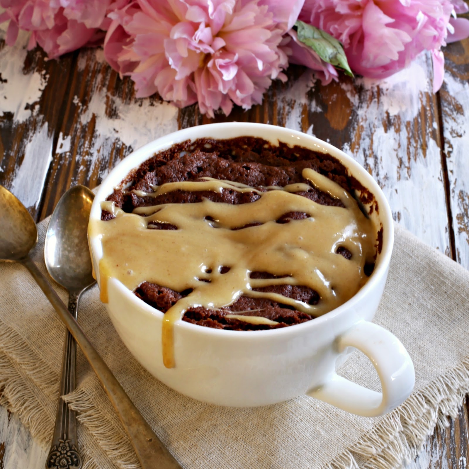 Recipe for a single serving chocolate cake, cooked in a microwave, and topped with a peanut butter glaze.