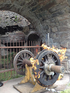 Metal wheel with fire around rim at Scranton Iron Furnaces event