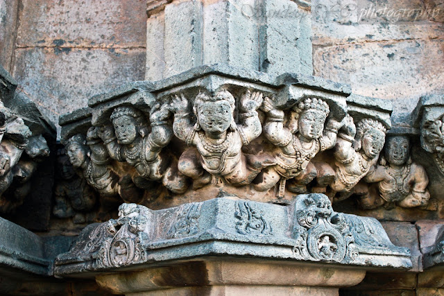 One more beautiful sculpture on the Suryanarayana Shrine, showing as if several men lifting the column on top of it which holds the shikara of the temple