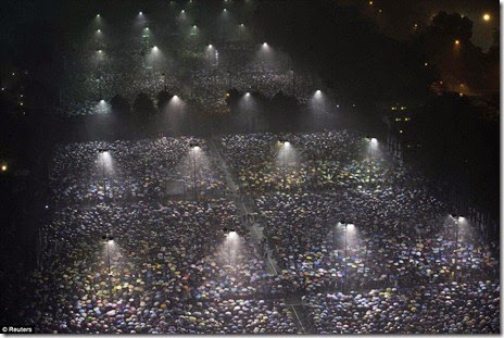 under heavy rain at Hong Kong's Victoria Park, June 4, 2013, to mark the 24th anniversary of the military crackdown of the pro-democracy movement at Beijing's Tiananmen Square in 1989