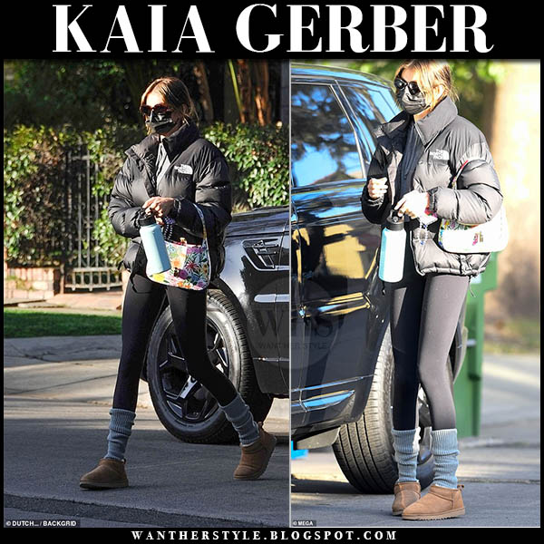 Kaia Gerber in black puffer jacket, black leggings and brown boots