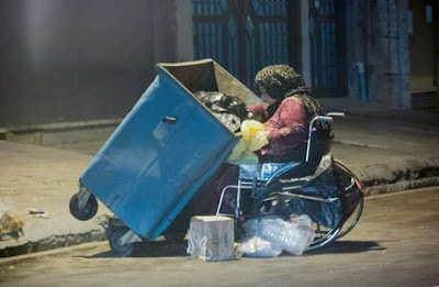 Disabled woman has to feed from the trash bin