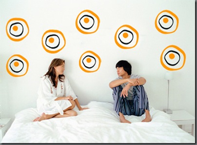 Couple sitting on bed