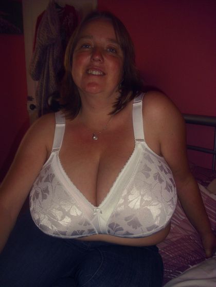 Chesty single with huge breasts in white brassiere