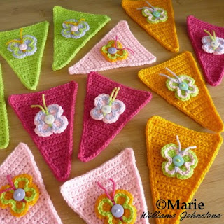 Crocheted button butterflies on party banner bunting