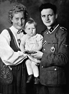 Parents pose with a child adopted from a Lebensborn eugenics center during WWII. (Keystone-France/Gamma-Keystone via Getty Images)