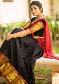 sitting image of isha reba in black and red saree