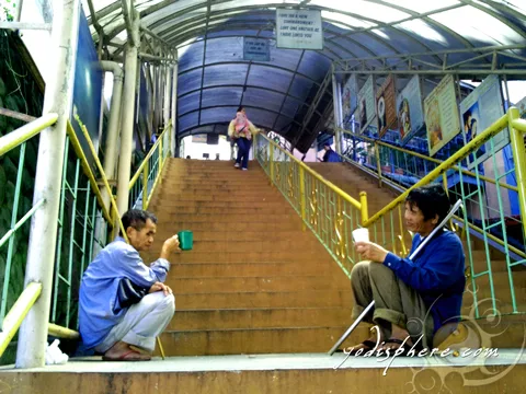 Two beggars sitting at the stairs going to the church