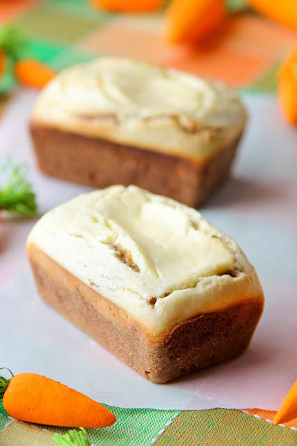 A small carrot cake loaf sitting in front of another