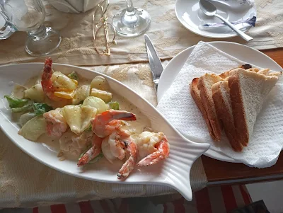 " Garlic cream shrimp platter with bread from Ramada by Wyndham Princess hotel & casino rooftop restaurant in Suriname"