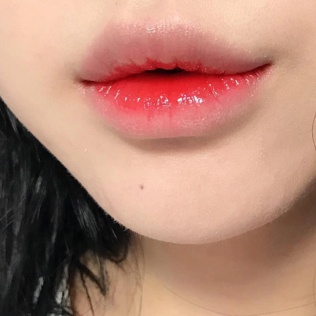 close-up of a half of a face with a cute, doll-like lip makeup