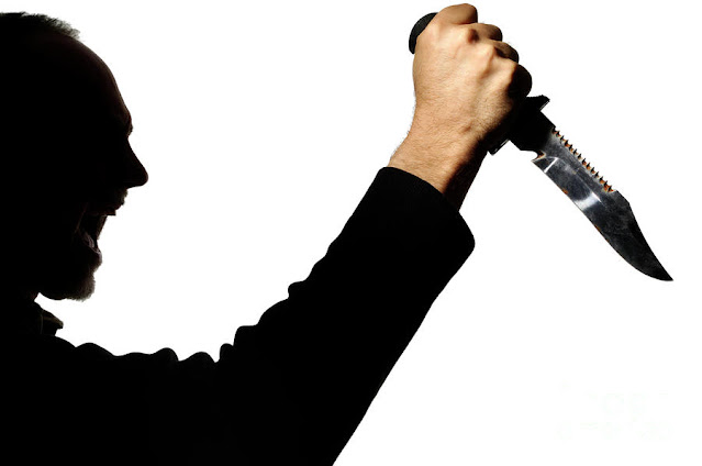 Shadow of a man with a knife