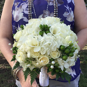 White bridal clutch bouquet with pearls by Stein Your Florist Co.