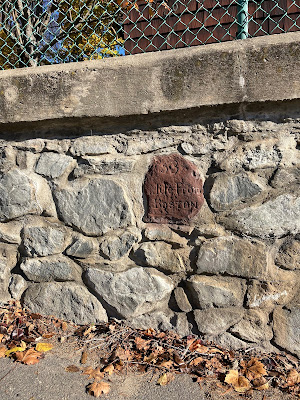 Post Road Milestone 53 in Leicester, Massachusetts is set into a stone retaining wall on the westbound side of Route 9.