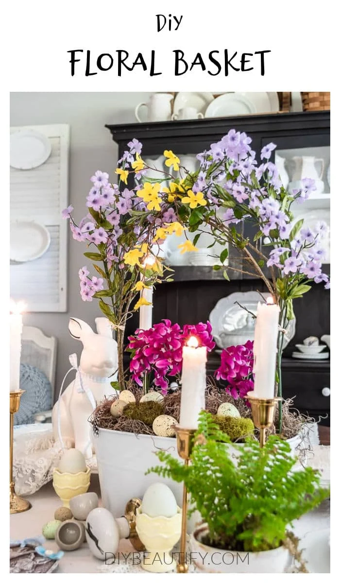 floral basket with branch handles, bunny, eggs in cups, greenery, candles