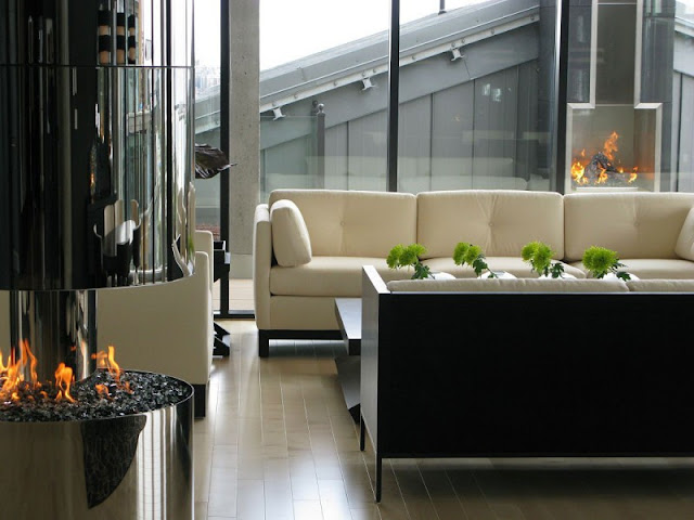 Picture of modern white sofa by the round fireplace in the living room