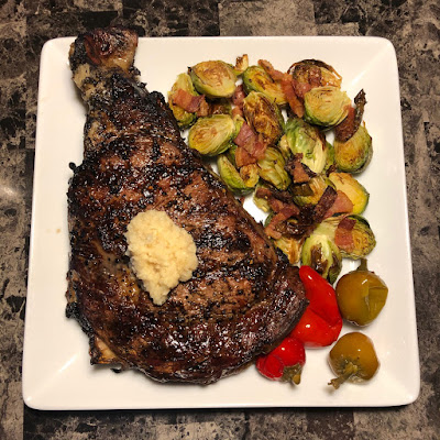 Rare grilled Angus ribeye and bacon roasted Brussels sprouts