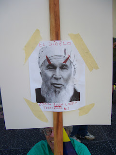 Photo: sign with Bush with a turban and devil's horns, saying, "El Diablo; Osama Bush Laden, terrorista #1"