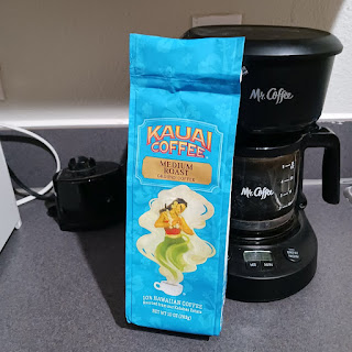 Bag of Kona coffee with coffee pot