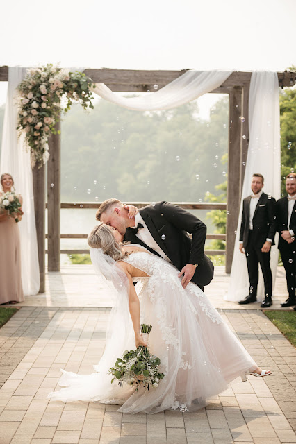 niagara wedding planner - ceremony officiant - jennie dobrucki - stonewall estates outdoor wedding ceremony on the water - dip and kiss during recessional