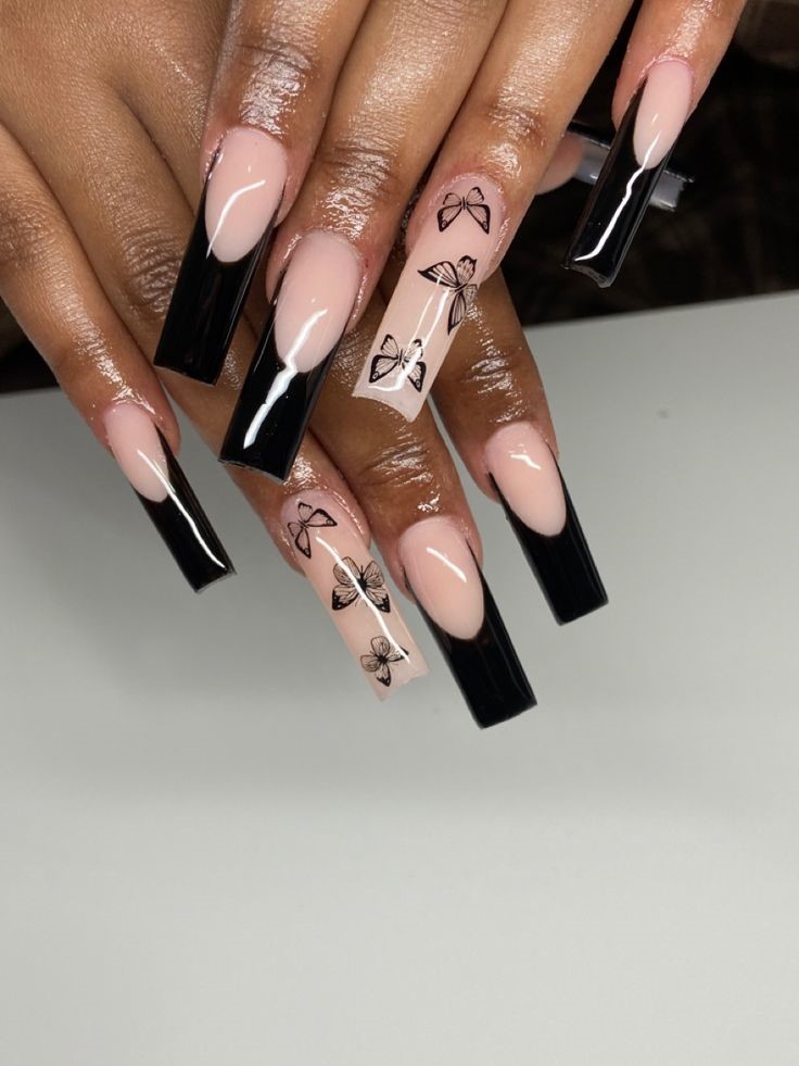black and nude french tip nails with butterfly nail art