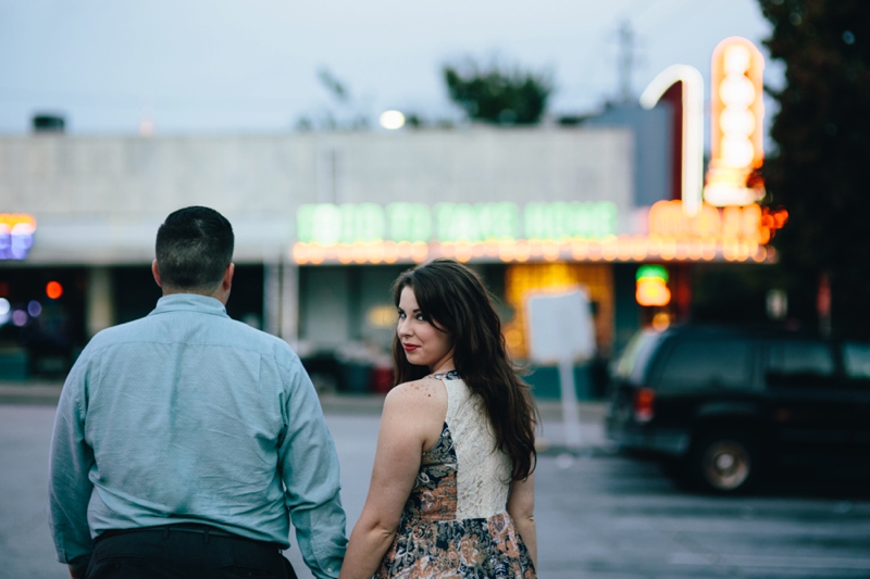 walking toward the Majestic Diner at their engagement session