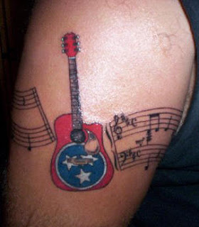 Armband tattoo of Musical Notes and Guitar