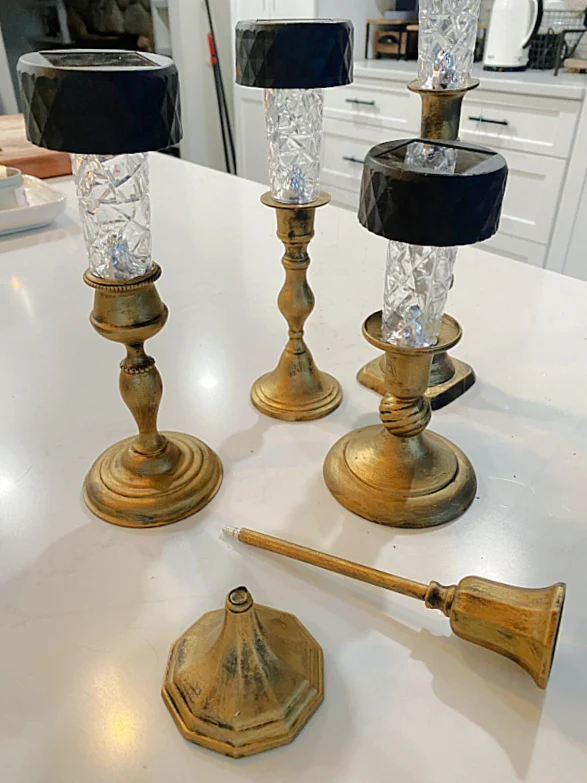 solar lights in brass candlesticks