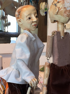 two Reflection Dancer puppets partly dresses, looking at each other in Corina Duyn's studio