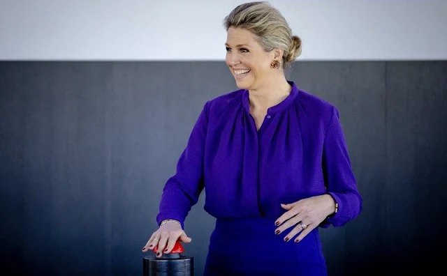 Queen Maxima wore a purple gathered neck blouse by Cos, and a purple a-line wool skirt by Cos