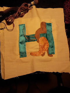 Letter H stage 1 - pinned down fabrics shaped and cut to size, working on lion skin first