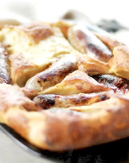 toad in the hole, a classic dish of sausages cooked in a yorkshire pudding batter served cut into sections