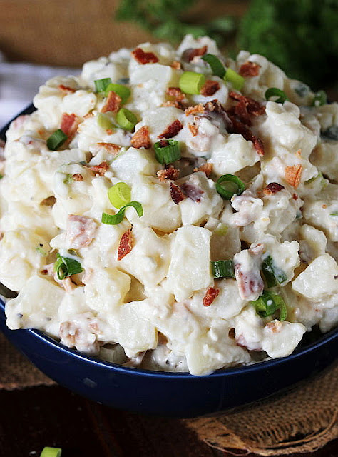 Close-Up of Bowl of Bacon & Blue Cheese Potato Salad Topped with Crumbled Bacon Image